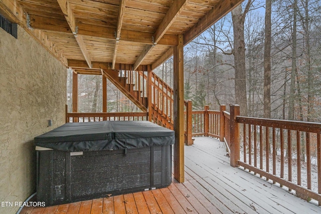 snow covered deck featuring a hot tub