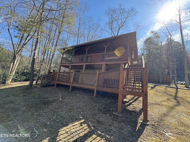 rear view of house featuring a deck