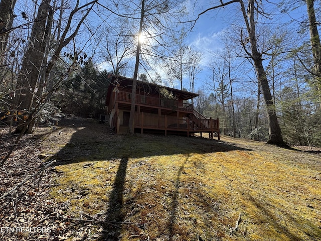 rear view of house with a wooden deck