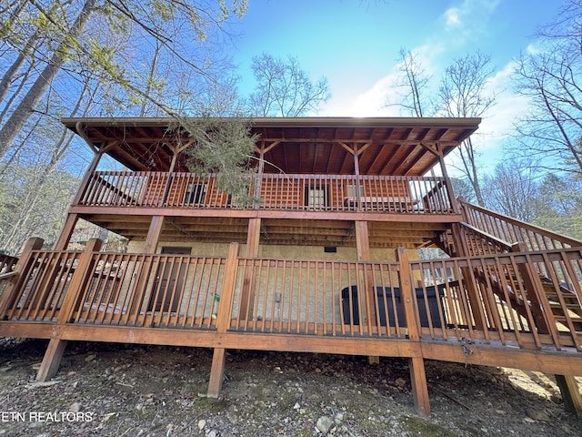 back of house with stairway and a wooden deck