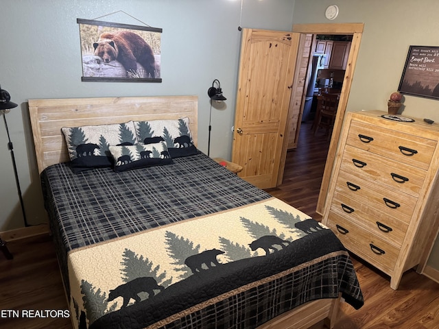 bedroom with dark wood finished floors