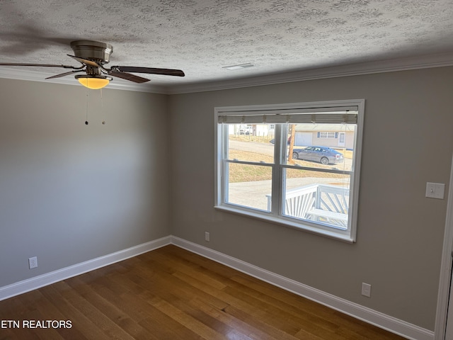 unfurnished room with a textured ceiling, ceiling fan, ornamental molding, and wood-type flooring