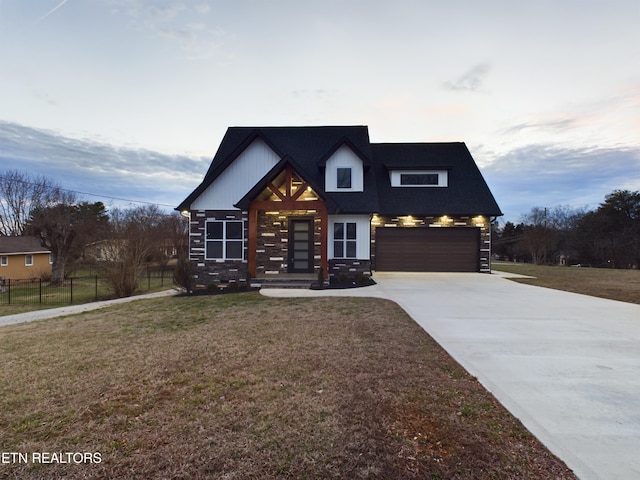 view of front facade featuring a garage, concrete driveway, a front yard, and fence