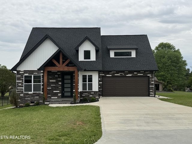 view of front of property with a front lawn, stone siding, a shingled roof, concrete driveway, and an attached garage