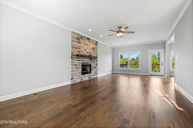 unfurnished living room with ceiling fan, a fireplace, dark hardwood / wood-style floors, and ornamental molding