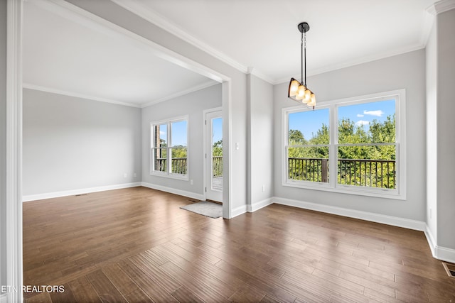 spare room with dark wood-type flooring and ornamental molding