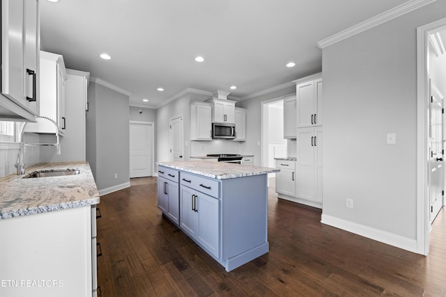 kitchen featuring backsplash, dark wood-type flooring, sink, light stone counters, and white cabinetry