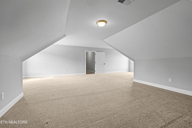 bonus room with carpet flooring and lofted ceiling