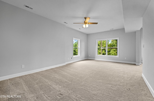 carpeted spare room with ceiling fan