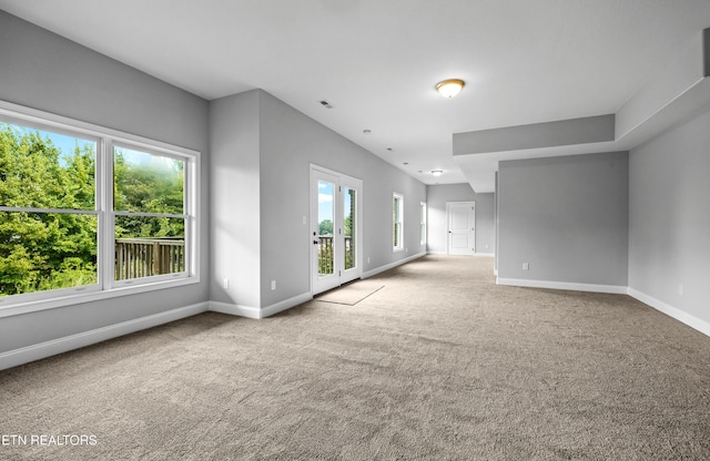 unfurnished living room featuring light colored carpet