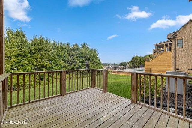 deck with a lawn and central AC