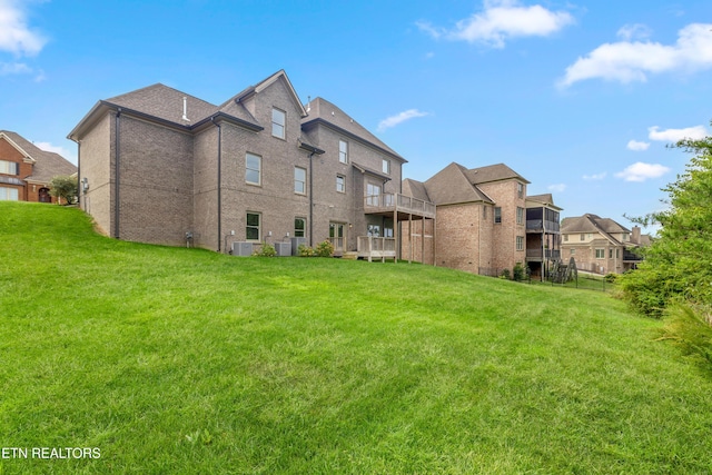 back of property featuring a lawn