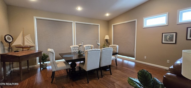 dining space with dark hardwood / wood-style floors and vaulted ceiling