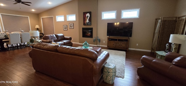 living room featuring dark hardwood / wood-style floors, ceiling fan, and high vaulted ceiling