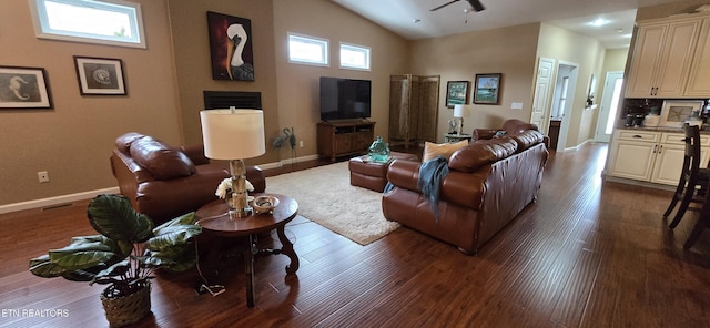 living room featuring dark hardwood / wood-style flooring and high vaulted ceiling