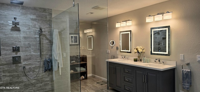 bathroom featuring hardwood / wood-style floors, vanity, and a shower with door