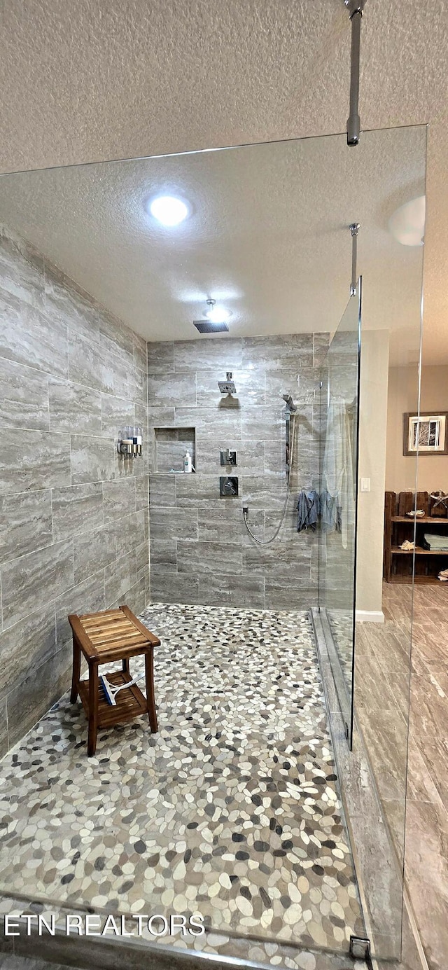 bathroom with tiled shower