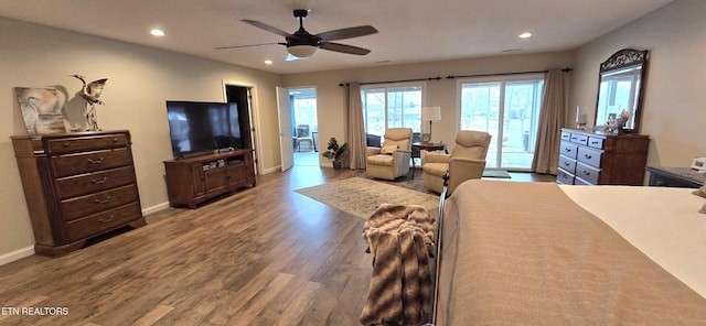 bedroom featuring hardwood / wood-style floors, ceiling fan, and access to outside