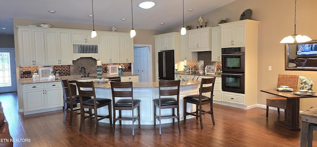 kitchen featuring pendant lighting, a center island, white cabinetry, and backsplash