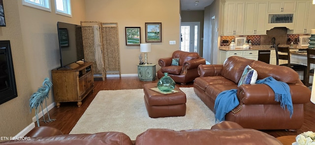 living room featuring a wealth of natural light and dark hardwood / wood-style flooring