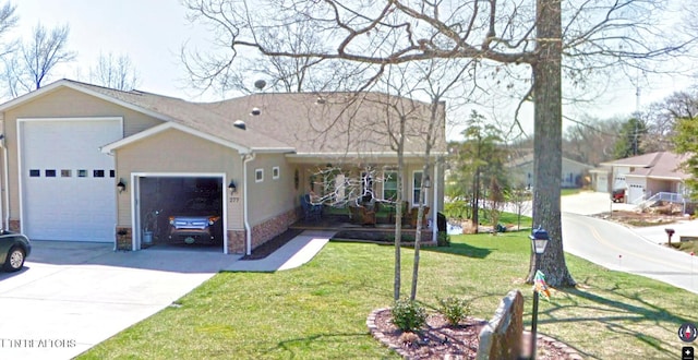 ranch-style house featuring an attached garage, a front lawn, and driveway