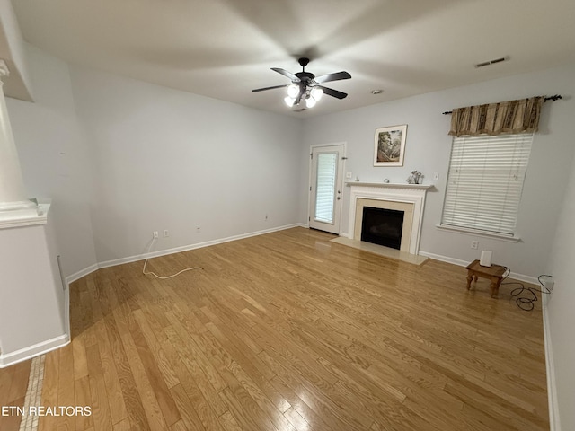 unfurnished living room featuring ceiling fan and light hardwood / wood-style floors