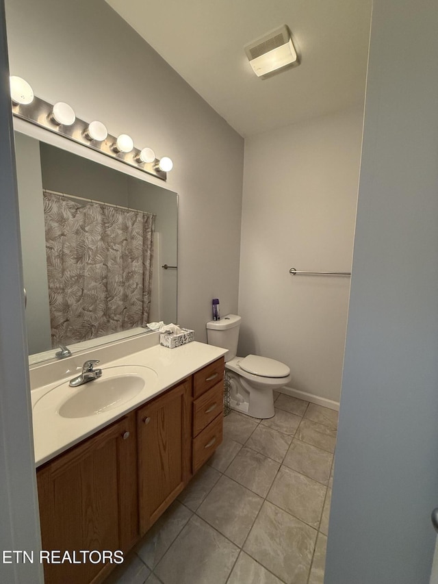 bathroom with tile patterned floors, vanity, and toilet