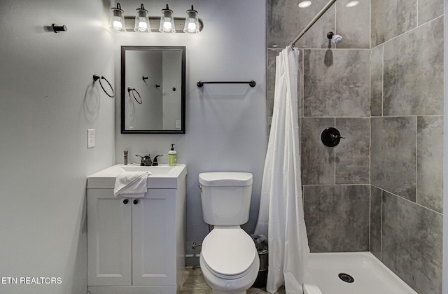 bathroom with vanity, toilet, and walk in shower