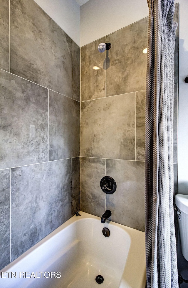 bathroom with shower / bathtub combination with curtain and toilet