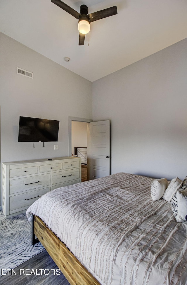 bedroom with ceiling fan and dark hardwood / wood-style floors