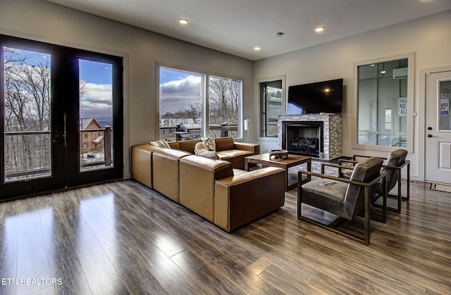 living room featuring a fireplace, dark hardwood / wood-style flooring, and french doors