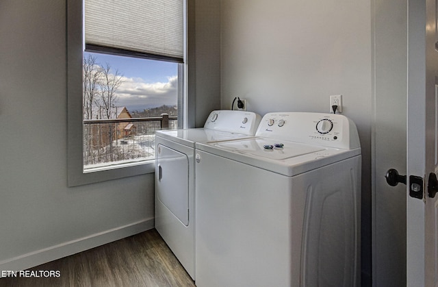 laundry room with wood-type flooring, separate washer and dryer, and a wealth of natural light