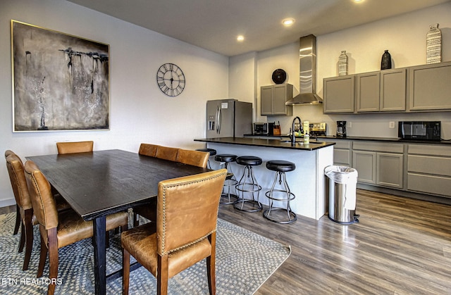 dining area with dark hardwood / wood-style floors and sink