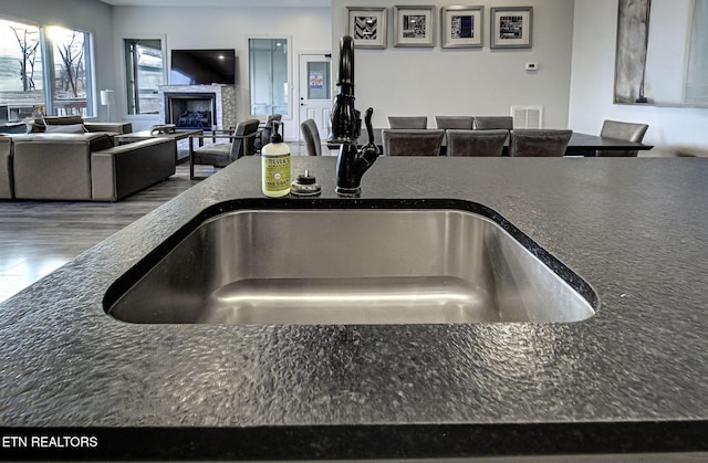 room details with dark stone countertops and sink