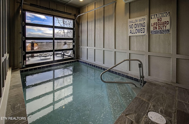 view of swimming pool with an indoor hot tub