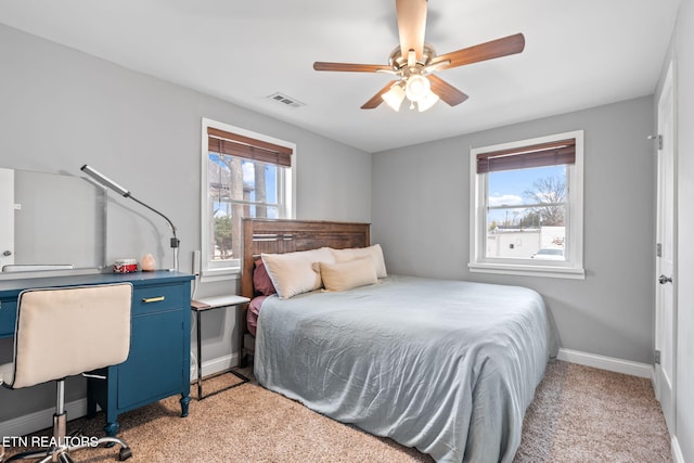 bedroom featuring ceiling fan and light carpet