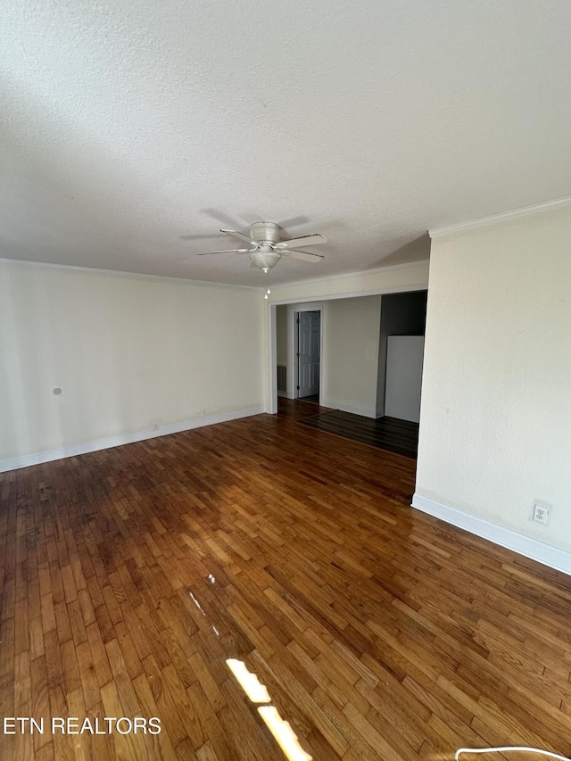 spare room with a textured ceiling, ceiling fan, and dark wood-type flooring