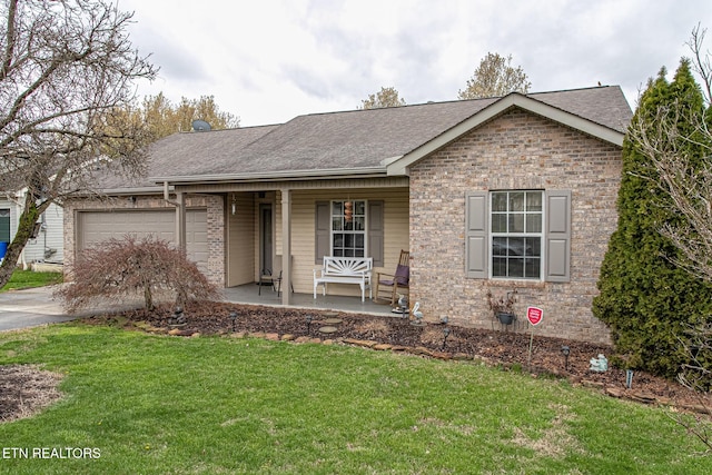 ranch-style house with a front yard, a porch, and a garage