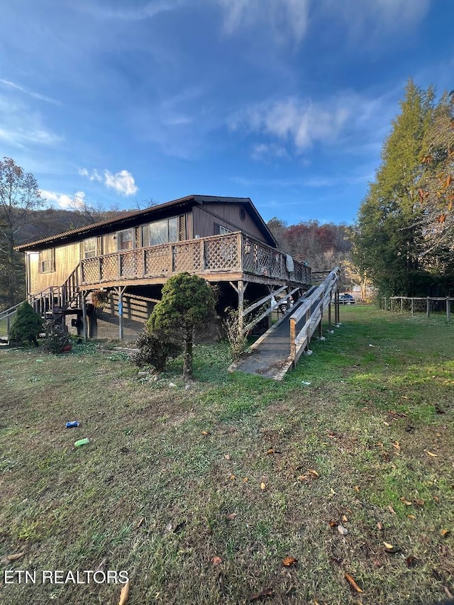 view of home's exterior featuring a deck and a yard