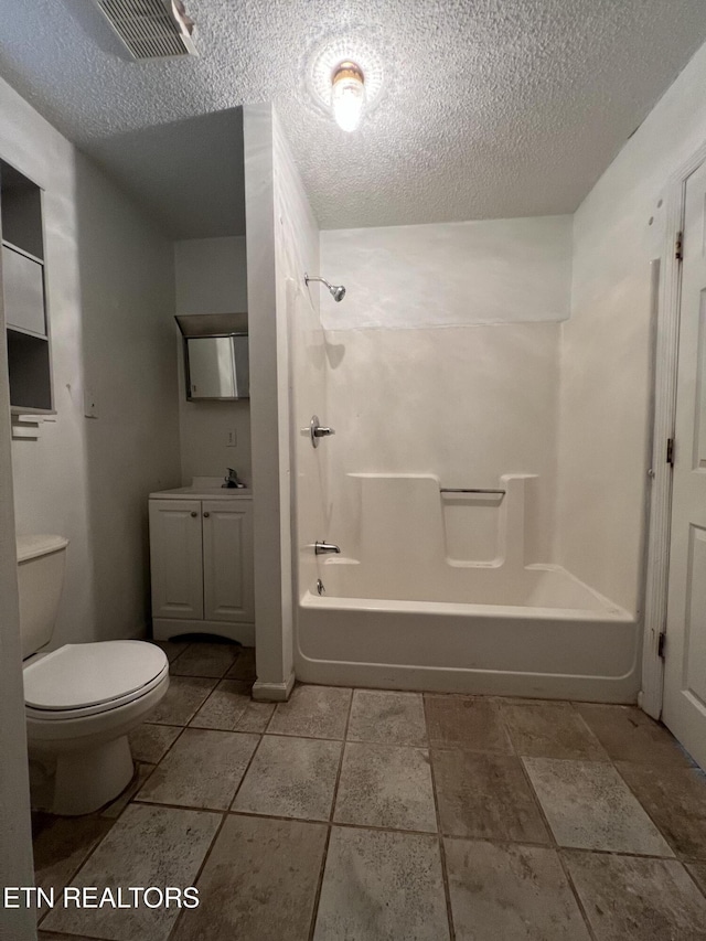 bathroom with a textured ceiling, toilet, visible vents, vanity, and tub / shower combination