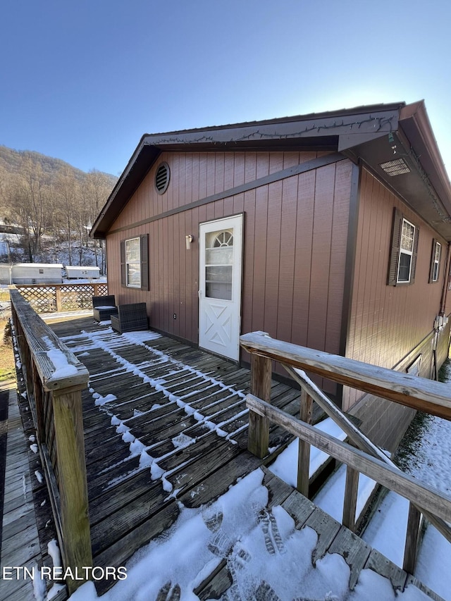 view of snowy exterior with a mountain view