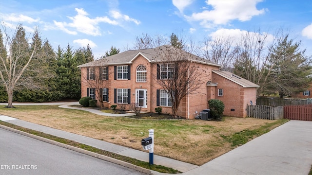 view of front of home featuring a front lawn and cooling unit