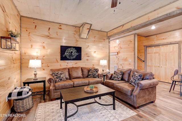 living room featuring wooden ceiling, wood walls, ceiling fan, and hardwood / wood-style flooring