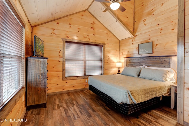 bedroom with dark wood-type flooring, wood walls, and ceiling fan