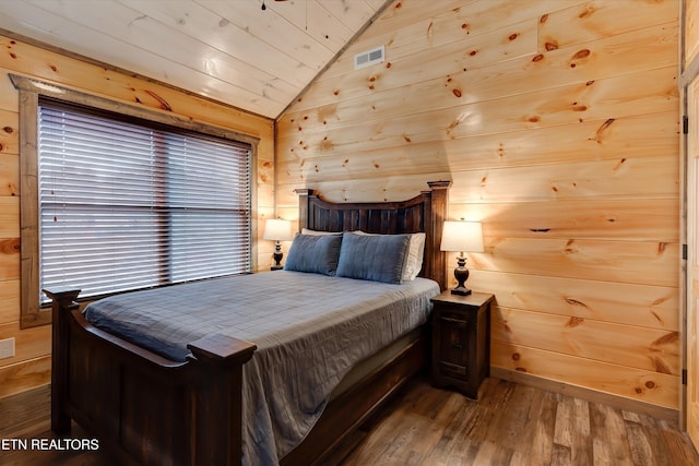 bedroom with wood ceiling, hardwood / wood-style floors, vaulted ceiling, and wood walls