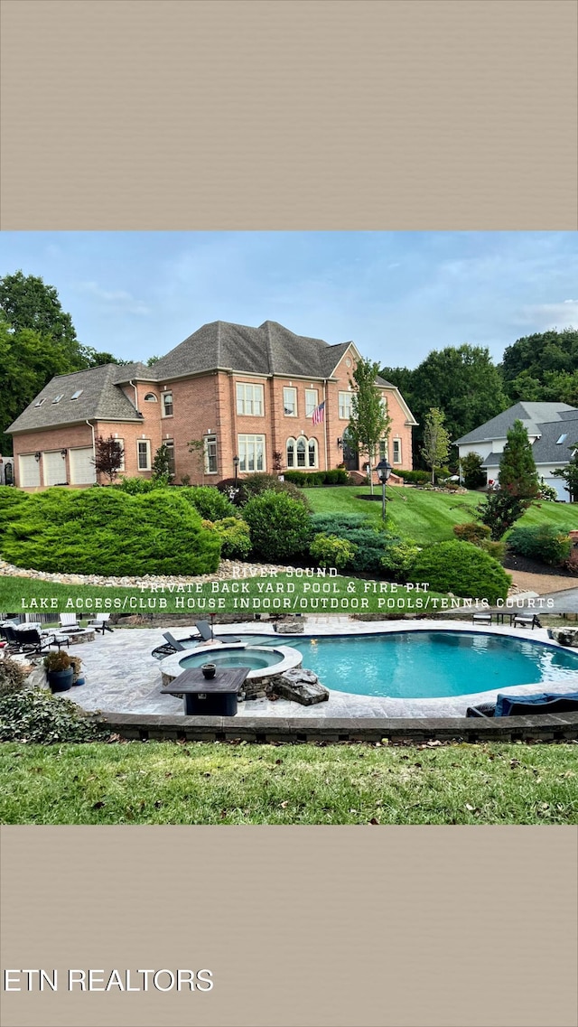 view of pool with an in ground hot tub