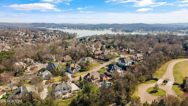 drone / aerial view featuring a residential view and a water view