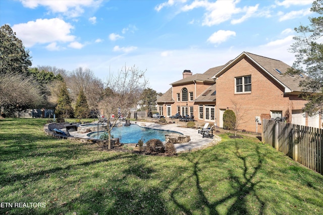 view of swimming pool with a fenced in pool, a hot tub, a lawn, a fenced backyard, and a patio area