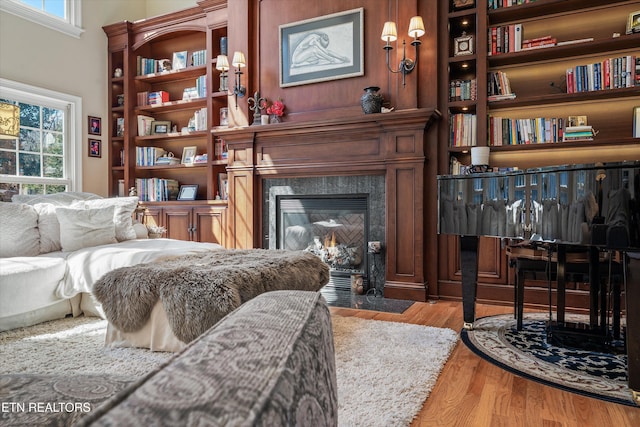 living room with wood finished floors and a premium fireplace