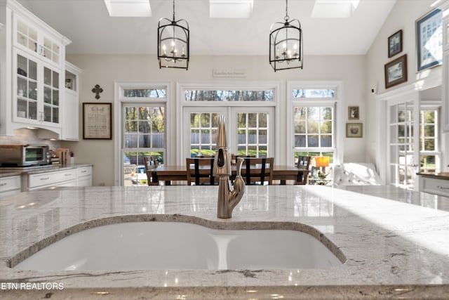 kitchen with plenty of natural light, french doors, and an inviting chandelier